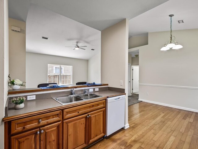 325 Chastain Ln, Tallahassee, FL 32305 - kitchen featuring brown cabinets, visible vents, white dishwasher, and a sink