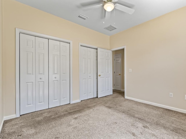 325 Chastain Ln, Tallahassee, FL 32305 - unfurnished bedroom with baseboards, visible vents, two closets, and carpet