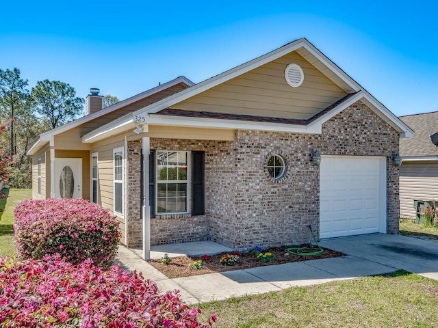 325 Chastain Ln, Tallahassee, FL 32305 - view of front of house featuring brick siding, driveway, a garage, and a chimney