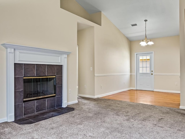 325 Chastain Ln, Tallahassee, FL 32305 - unfurnished living room with vaulted ceiling, carpet, baseboards, a chandelier, and visible vents