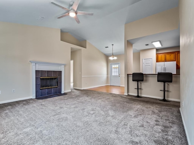 325 Chastain Ln, Tallahassee, FL 32305 - unfurnished living room with vaulted ceiling, carpet, baseboards, ceiling fan, and a fireplace