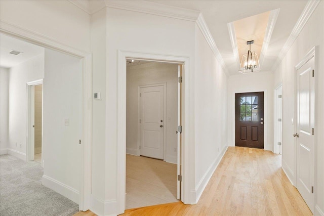 3833 Ardmore Ln, Tallahassee, FL 32308 - foyer entrance with a chandelier, light wood-type flooring, baseboards, ornamental molding, and visible vents