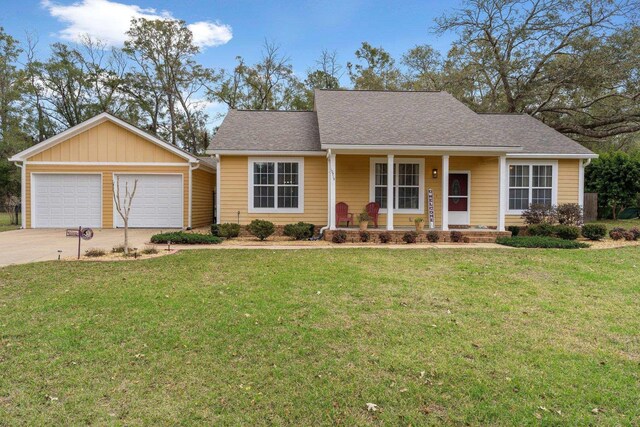 10715 Sycamore Ridge Ln, Tallahassee, FL 32305 - ranch-style home with covered porch, a front lawn, roof with shingles, and a garage