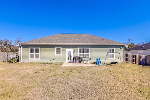 back of property with a patio area and a yard