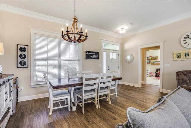 dining space featuring dark wood-type flooring, crown molding, a healthy amount of sunlight, and an inviting chandelier