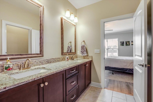 bathroom with tile patterned flooring, crown molding, and vanity