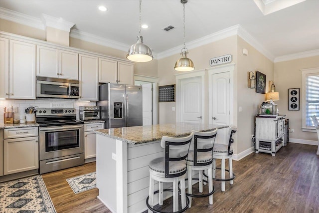 kitchen with white cabinets, stainless steel appliances, and a center island