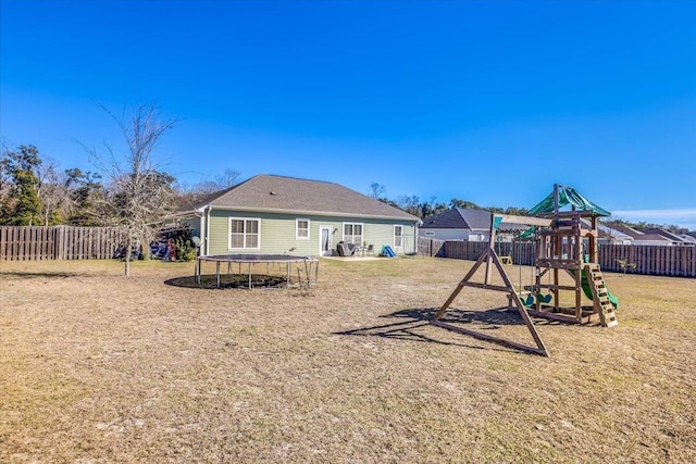 view of playground with a lawn and a trampoline