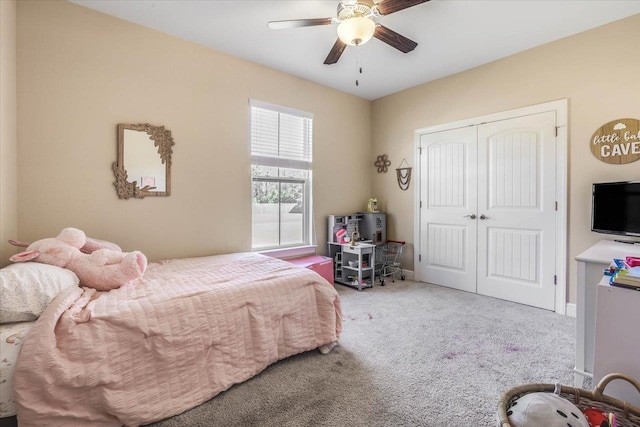 carpeted bedroom featuring ceiling fan and a closet