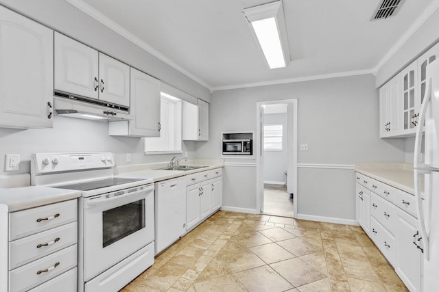 kitchen featuring white cabinets, ornamental molding, sink, and white appliances