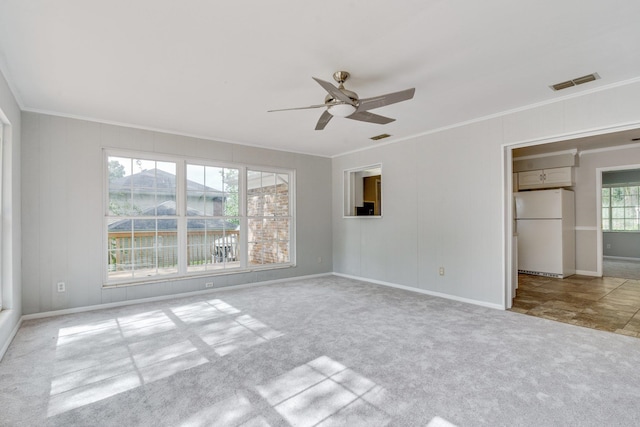 unfurnished room featuring light colored carpet and crown molding