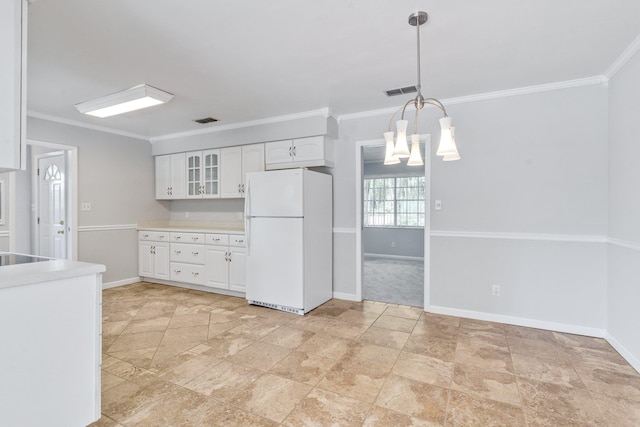 kitchen featuring crown molding, white refrigerator, a notable chandelier, hanging light fixtures, and white cabinets