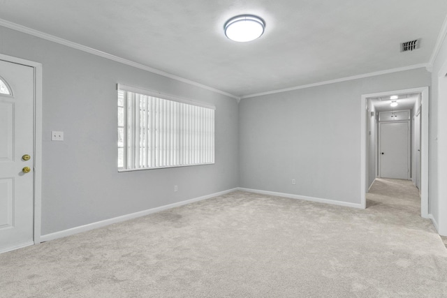 spare room featuring light colored carpet and crown molding