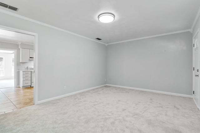 carpeted spare room featuring ornamental molding