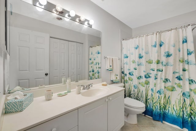 bathroom featuring toilet, curtained shower, tile patterned flooring, vanity, and a closet