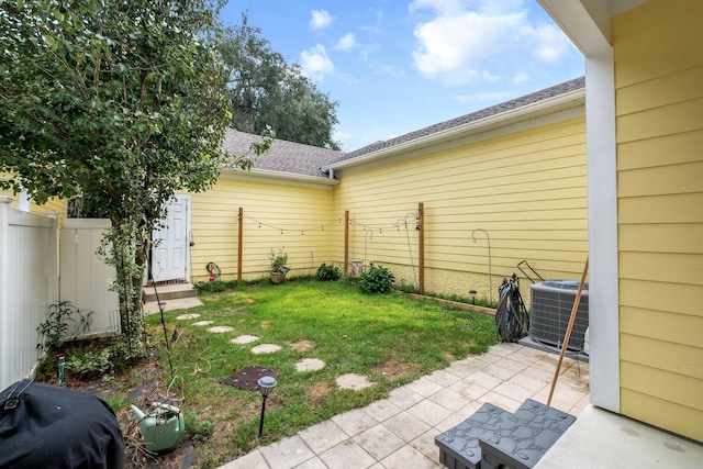 view of yard featuring fence, cooling unit, and a patio