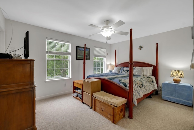 bedroom with ceiling fan, baseboards, and light colored carpet