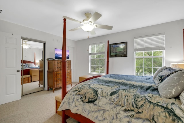 carpeted bedroom with a ceiling fan and visible vents