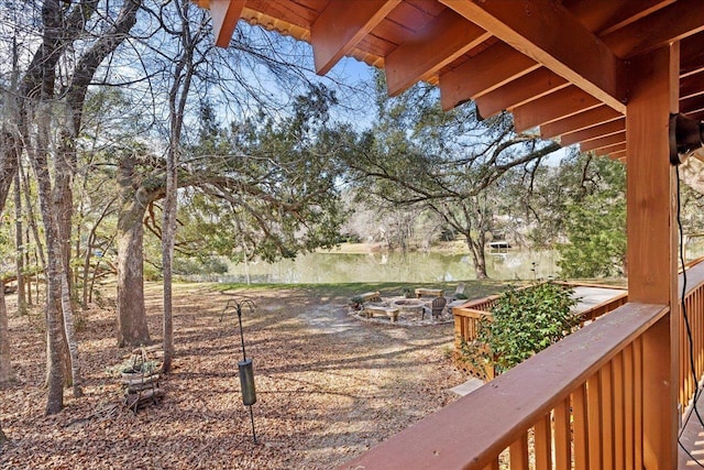 view of yard with an outdoor fire pit and a water view