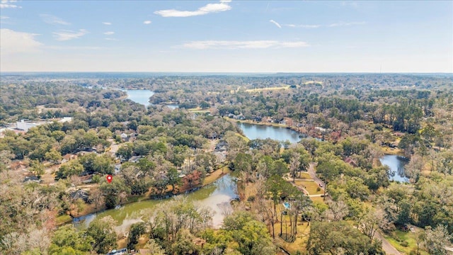 aerial view with a forest view and a water view