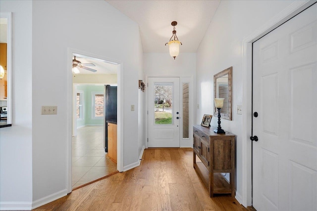 foyer entrance with light wood-type flooring and baseboards