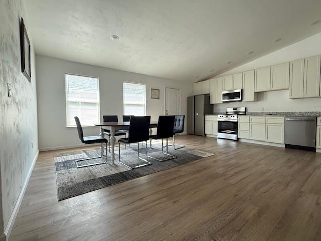 2754 Roberts Ave, Tallahassee, FL 32310 - dining area with vaulted ceiling, baseboards, and wood finished floors