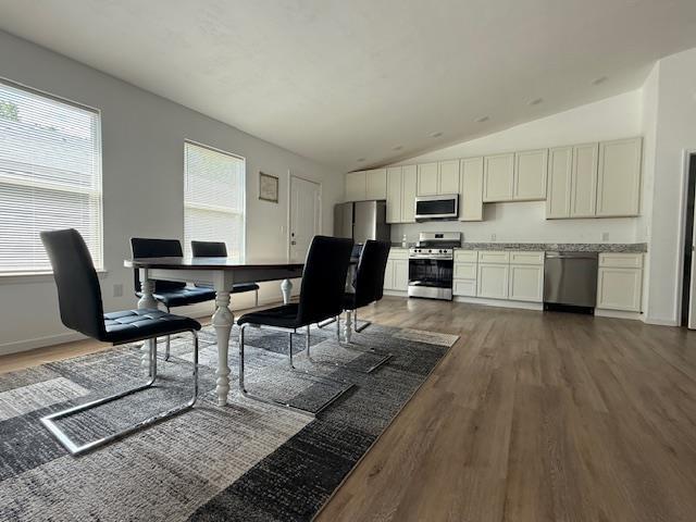 2754 Roberts Ave, Tallahassee, FL 32310 - dining area featuring vaulted ceiling, dark wood-style floors, and baseboards