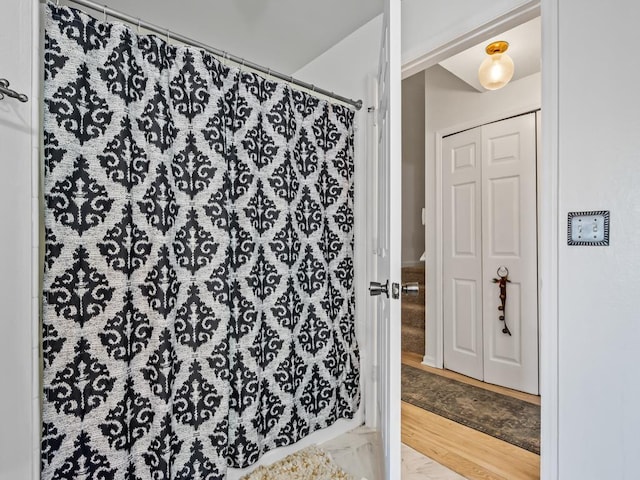 bathroom featuring a shower with shower curtain and hardwood / wood-style floors