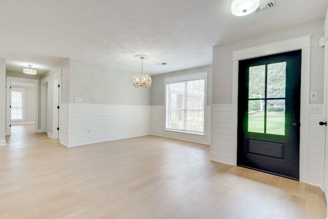 3585 Gardenview Way, Tallahassee, FL 32309 - entryway featuring wainscoting, a chandelier, plenty of natural light, and light wood-style flooring