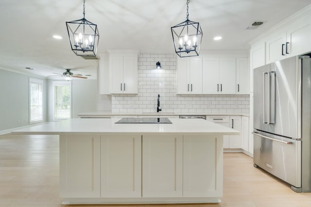 3585 Gardenview Way, Tallahassee, FL 32309 - kitchen featuring stainless steel appliances, a chandelier, a kitchen island, light countertops, and ornamental molding