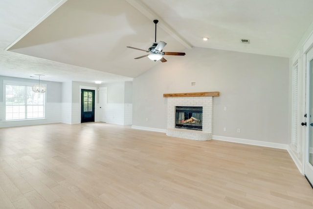 3585 Gardenview Way, Tallahassee, FL 32309 - unfurnished living room featuring a chandelier, a brick fireplace, wainscoting, light wood finished floors, and ceiling fan
