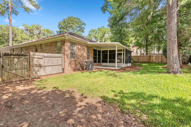 3585 Gardenview Way, Tallahassee, FL 32309 - rear view of house featuring brick siding, a sunroom, a chimney, and a gate