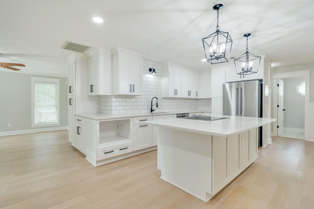 3585 Gardenview Way, Tallahassee, FL 32309 - kitchen featuring a chandelier, tasteful backsplash, a center island, white cabinetry, and open shelves
