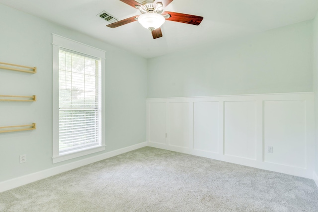 3585 Gardenview Way, Tallahassee, FL 32309 - empty room with carpet floors, a ceiling fan, a wainscoted wall, and a decorative wall