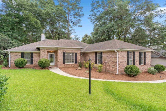 3585 Gardenview Way, Tallahassee, FL 32309 - single story home featuring a front lawn, roof with shingles, a chimney, and brick siding