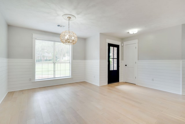 3585 Gardenview Way, Tallahassee, FL 32309 - foyer entrance featuring a wainscoted wall, a chandelier, healthy amount of natural light, wood walls, and light wood finished floors