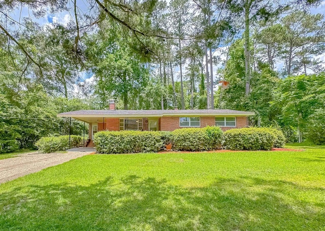 1514 Sharon Rd, Tallahassee, FL 32303 - ranch-style home with brick siding, dirt driveway, a front lawn, a chimney, and an attached carport