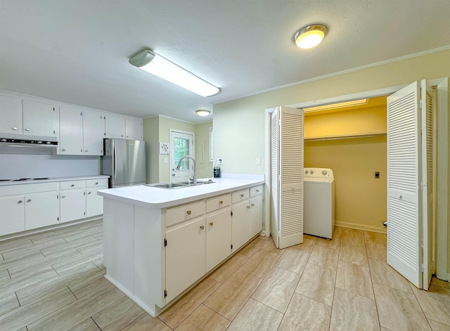 1514 Sharon Rd, Tallahassee, FL 32303 - kitchen featuring washer / clothes dryer, freestanding refrigerator, a peninsula, wood tiled floors, and light countertops