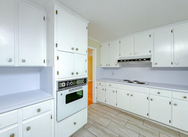1514 Sharon Rd, Tallahassee, FL 32303 - kitchen with white appliances, range hood, light countertops, and white cabinetry
