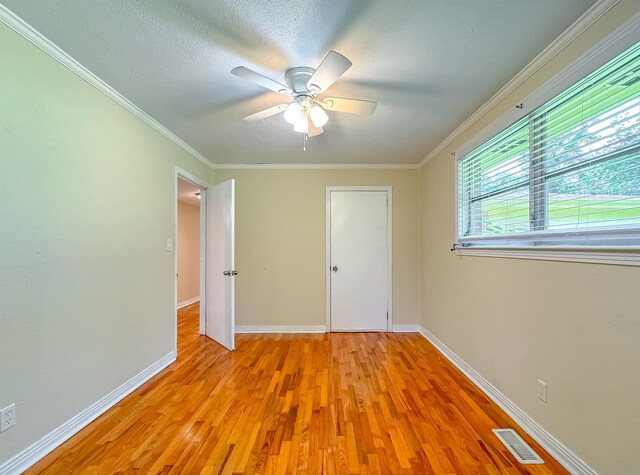 1514 Sharon Rd, Tallahassee, FL 32303 - unfurnished bedroom featuring light wood-style flooring, ornamental molding, and ceiling fan