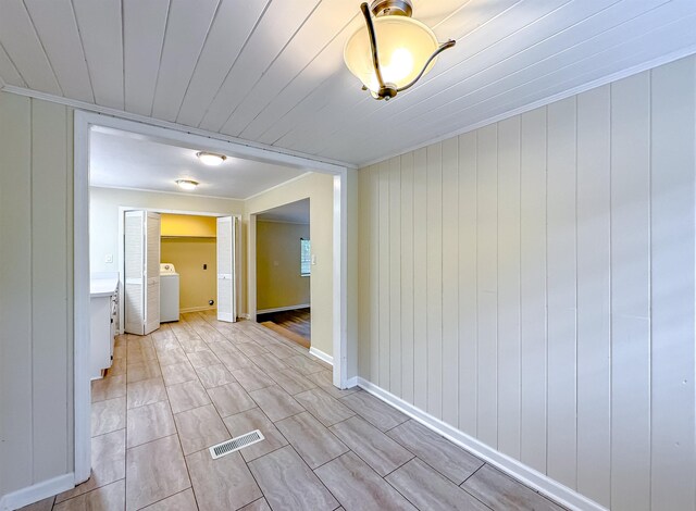1514 Sharon Rd, Tallahassee, FL 32303 - empty room featuring washer / clothes dryer, crown molding, and light wood finished floors