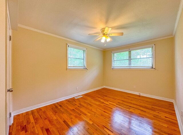 1514 Sharon Rd, Tallahassee, FL 32303 - spare room featuring light wood-type flooring, a ceiling fan, and crown molding