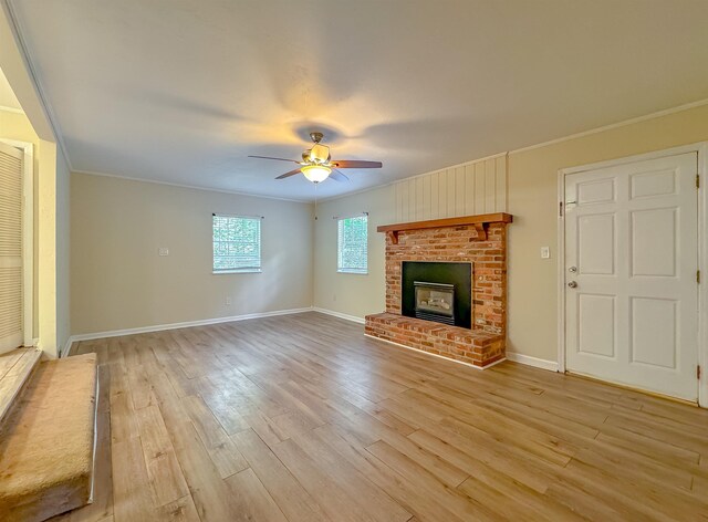 1514 Sharon Rd, Tallahassee, FL 32303 - unfurnished living room with ornamental molding, light wood-style floors, ceiling fan, and a brick fireplace