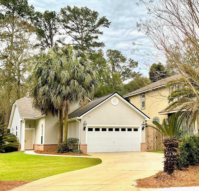 view of front facade featuring brick siding, stucco siding, concrete driveway, an attached garage, and a front lawn