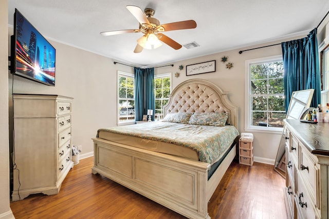 705 N 11th St, Quincy, FL 32351 - bedroom with wood finished floors, baseboards, multiple windows, a ceiling fan, and crown molding