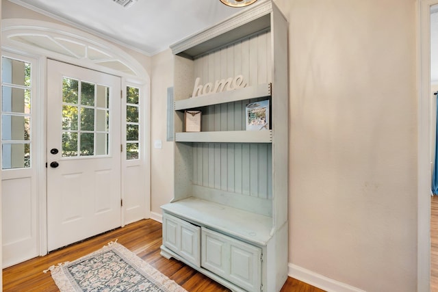 705 N 11th St, Quincy, FL 32351 - doorway to outside featuring wood finished floors, ornamental molding, and baseboards