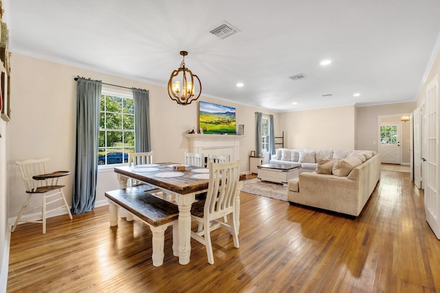 705 N 11th St, Quincy, FL 32351 - dining area featuring crown molding, a chandelier, healthy amount of natural light, light wood finished floors, and baseboards