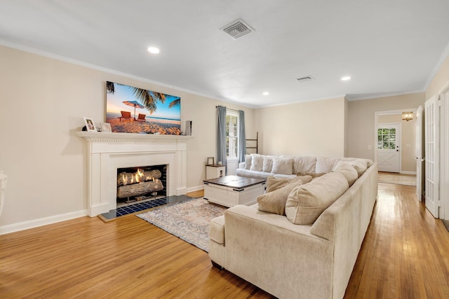 705 N 11th St, Quincy, FL 32351 - living room with ornamental molding, light wood-type flooring, baseboards, recessed lighting, and a lit fireplace