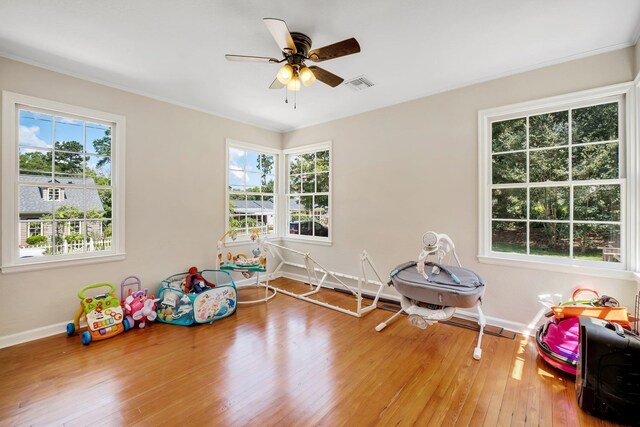 705 N 11th St, Quincy, FL 32351 - game room with healthy amount of natural light, baseboards, wood-type flooring, ceiling fan, and crown molding
