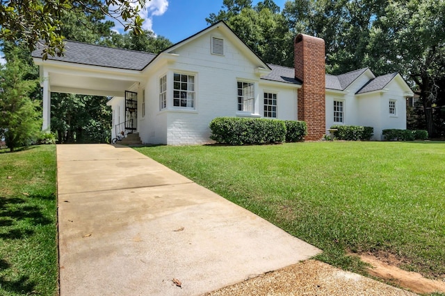 705 N 11th St, Quincy, FL 32351 - view of front of property featuring a shingled roof, a front lawn, concrete driveway, a chimney, and an attached carport